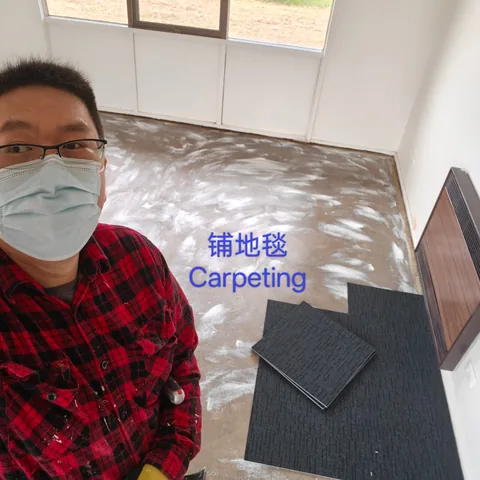 Carpet tiles stacked on a prepared concrete floor ready to lay
