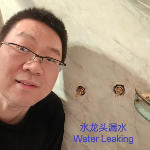 Wall tap spindles exposed in tiling while a leak is checked