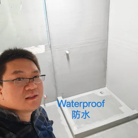 Shower base and walls coated with white waterproofing membrane