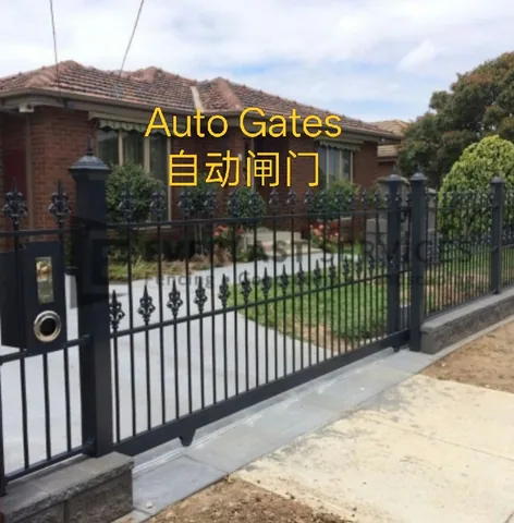 Automatic sliding gate on a driveway track in front of a brick house